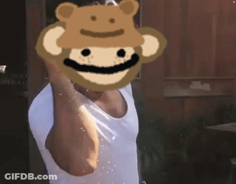 A Man Wearing A White Tank Top With A Monkey Face On His Face GIF