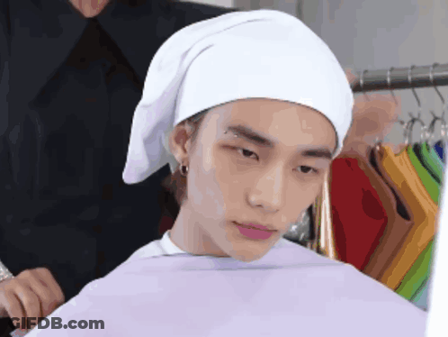 Man With White Towel Looks At Something GIF