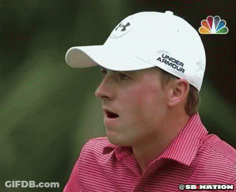 A Man Wearing A White Under Armour Hat Is Making A Funny Face GIF