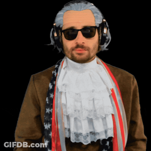 A Man Wearing A Wig And Sunglasses Has A Scarf Around His Neck GIF