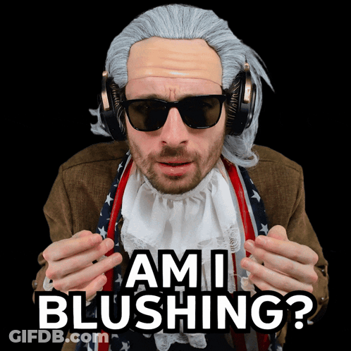 A Man Wearing A Wig And Sunglasses Has The Words Ami Blushing On His Face GIF