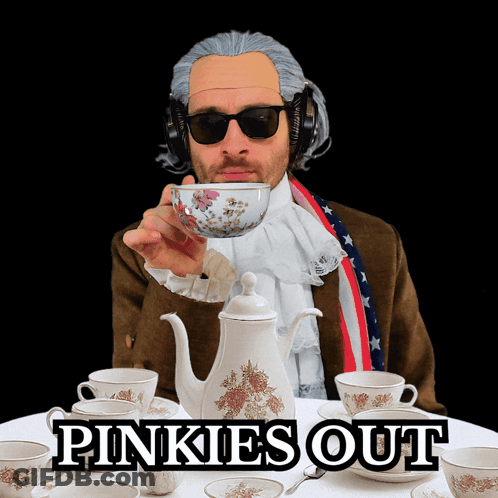 A Man Wearing A Wig And Sunglasses Holds A Cup Of Tea In Front Of A Table With Pinkies Out Written On The Table GIF
