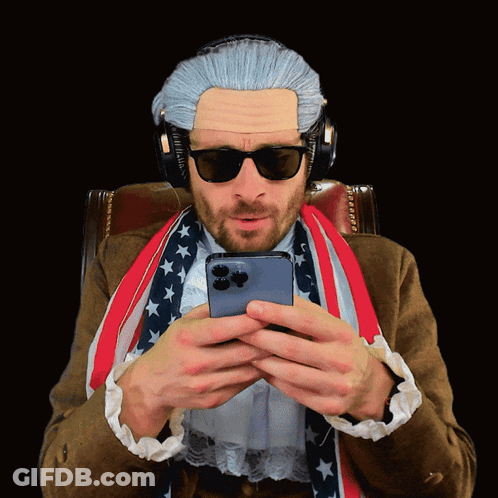 A Man Wearing A Wig And Sunglasses Is Looking At His Cell Phone GIF