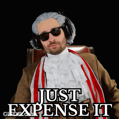 A Man Wearing A Wig And Sunglasses Is Sitting In A Chair With The Words Just Expense It Above Him GIF