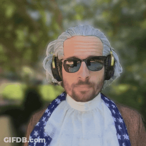 A Man Wearing A Wig And Sunglasses Is Wearing Headphones And A Scarf GIF