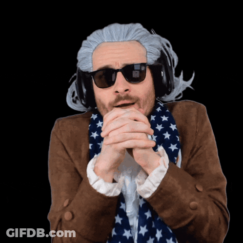 A Man Wearing A Wig And Sunglasses With The Letter N On His Face GIF