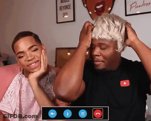 A Man Wearing A Wig Talks To Another Man GIF