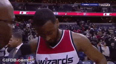 A Man Wearing A Wizards Jersey Is Talking To A Reporter GIF