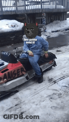 A Man Wearing A Wolf Mask Is Sitting On A Snowmobile That Says Larry GIF