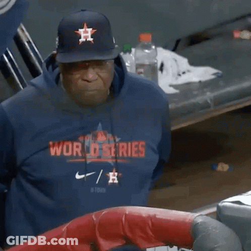 A Man Wearing A World Series Sweatshirt And A Hat GIF
