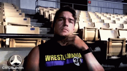 A Man Wearing A Wrestlemania 34 Tank Top GIF