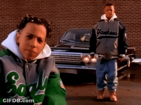 A Man Wearing A Yankees Jacket Stands Next To A Boy Wearing A Green Jacket GIF