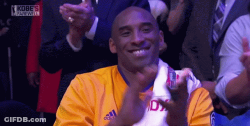 A Man Wearing A Yellow Adidas Shirt Is Smiling And Applauding GIF