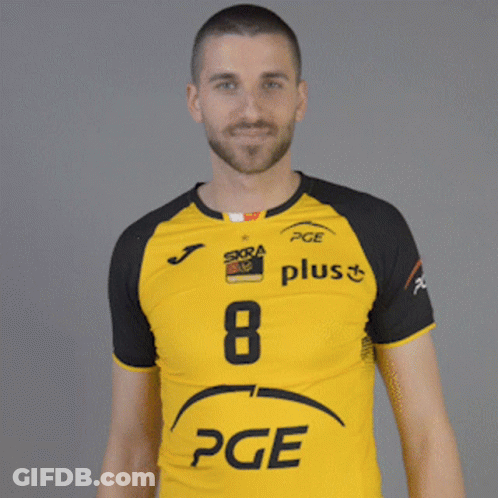 A Man Wearing A Yellow And Black Pge Plus Shirt GIF