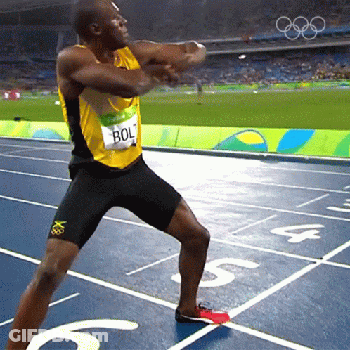 A Man Wearing A Yellow And Black Shirt With Bolt On It GIF