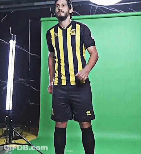 A Man Wearing A Yellow And Black Striped Jersey With The Word Rabbit On The Front GIF