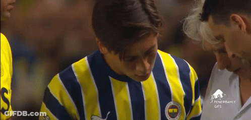A Man Wearing A Yellow And Blue Striped Shirt With The Word Fenerbahce On The Front GIF
