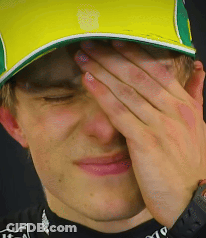 A Man Wearing A Yellow And Green Hat Covering His Face GIF