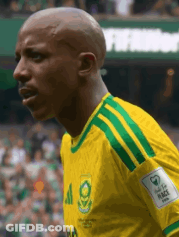 A Man Wearing A Yellow And Green Jersey With The Number 20 On It GIF