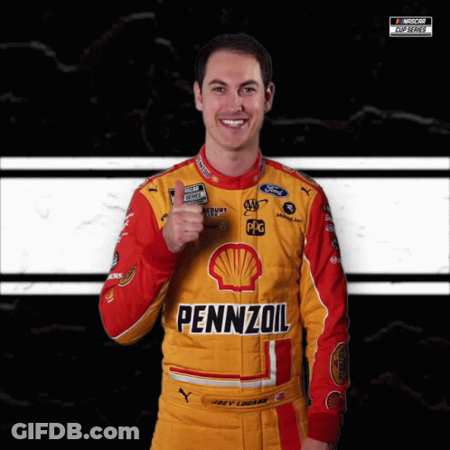 A Man Wearing A Yellow And Red Pennzoil Racing Suit Giving A Thumbs Up GIF