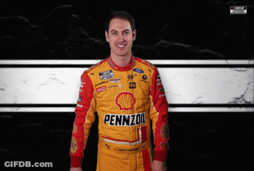 A Man Wearing A Yellow And Red Pennzoil Racing Suit GIF