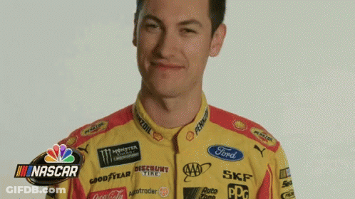 A Man Wearing A Yellow And Red Racing Suit With Nascar Written On The Bottom GIF