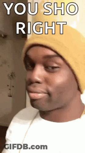 A Man Wearing A Yellow Beanie Is Making A Funny Face . GIF