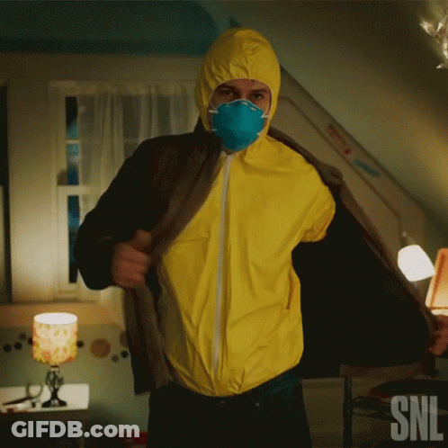 A Man Wearing A Yellow Coverall And A Mask With Snl Written On The Bottom Right GIF