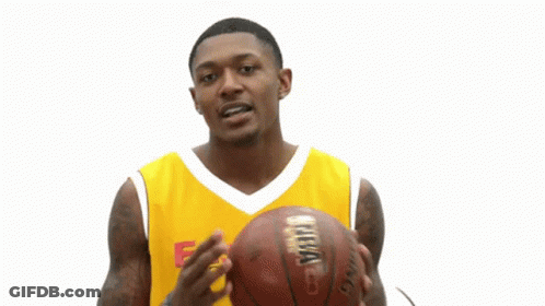 A Man Wearing A Yellow Easterns Automotive Group Jersey Holds A Basketball GIF