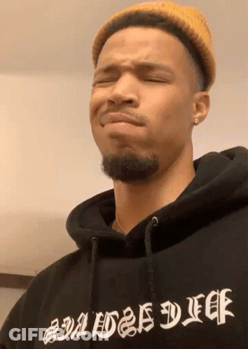 A Man Wearing A Yellow Hat And A Black Hoodie That Says Baddest Duff GIF