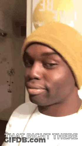 A Man Wearing A Yellow Hat And A White Shirt Is Making A Funny Face And Saying `` That Right There '' . GIF