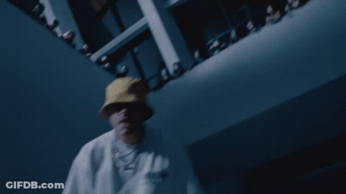 A Man Wearing A Yellow Hat And A White Shirt With The Word Adidas On It Is Dancing In Front Of A Crowd GIF