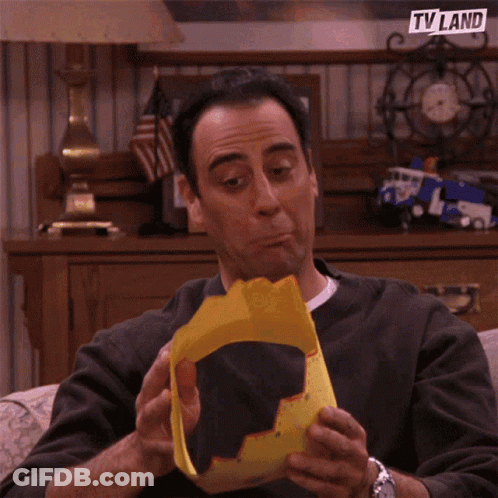 A Man Wearing A Yellow Hat With A Tv Land Logo On It GIF