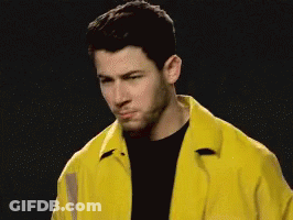 A Man Wearing A Yellow Jacket And A Black Shirt GIF