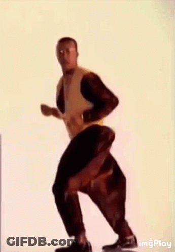 A Man Wearing A Yellow Jacket And Black Pants Is Dancing . GIF