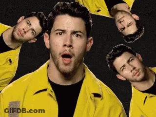 A Man Wearing A Yellow Jacket Is Surrounded By Other Men GIF