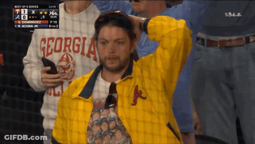 A Man Wearing A Yellow Jacket With Georgia On It GIF