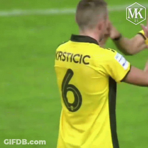 A Man Wearing A Yellow Jersey With Krsticic On The Back GIF