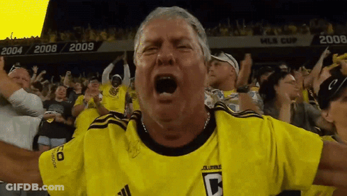 A Man Wearing A Yellow Jersey With The Letter C On The Front GIF