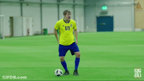 A Man Wearing A Yellow Jersey With The Number 1 On It Is Laughing With His Eyes Closed . GIF