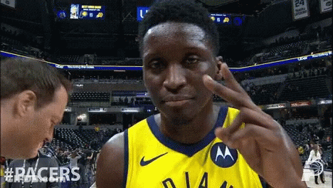 A Man Wearing A Yellow Jersey With The Word Racers On The Front GIF