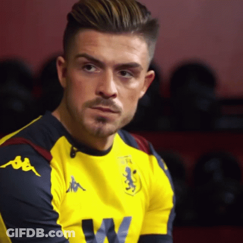 A Man Wearing A Yellow Kappa Shirt Looks To The Side GIF