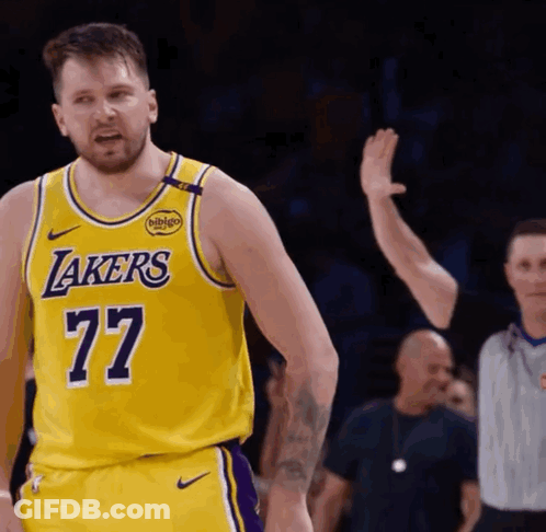 A Man Wearing A Yellow Lakers Jersey With The Number 77 GIF