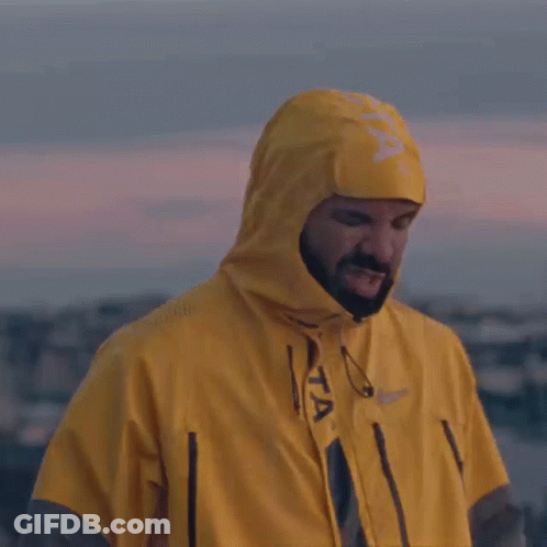 A Man Wearing A Yellow Raincoat With A Hood GIF