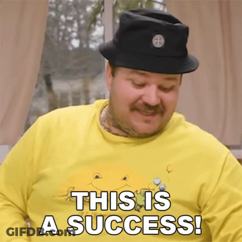 A Man Wearing A Yellow Shirt And A Black Hat Says This Is A Success GIF