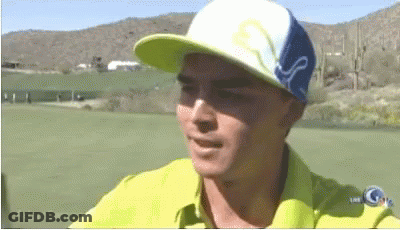 A Man Wearing A Yellow Shirt And A Blue And White Hat With The Word Puma On It GIF