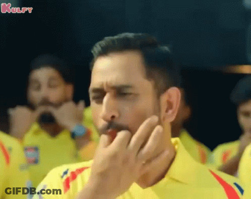 A Man Wearing A Yellow Shirt Is Covering His Mouth With His Hand And The Word Kulfy Is On The Bottom GIF