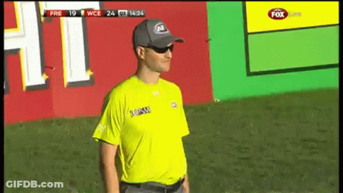A Man Wearing A Yellow Shirt That Says ' Fox Sports ' On It GIF