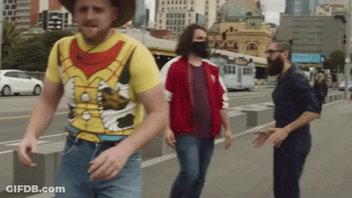 Man In Yellow Shirt With Cow Walking GIF
