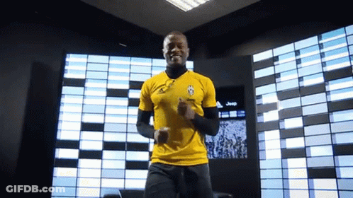 A Man Wearing A Yellow Shirt With A Jeep Logo On It GIF